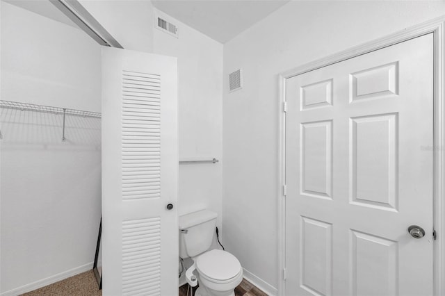 9602 Lake Chase Island Way Unit 9602, Tampa, FL 33626 - bathroom featuring baseboards, toilet, and a closet