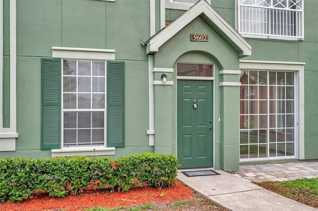 9602 Lake Chase Island Way Unit 9602, Tampa, FL 33626 - view of exterior entry featuring stucco siding