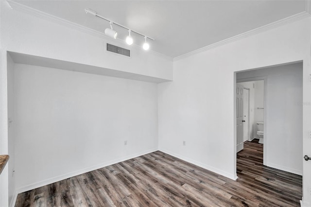 9602 Lake Chase Island Way Unit 9602, Tampa, FL 33626 - empty room featuring rail lighting, wood finished floors, crown molding, and baseboards