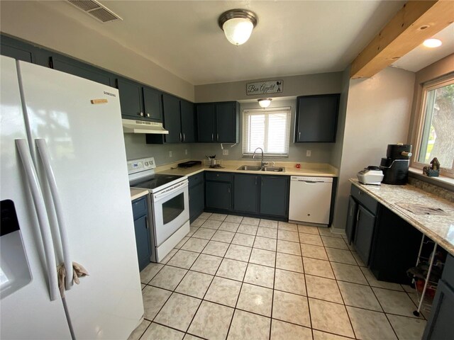 12912 Leadwood Dr, Riverview, FL 33579 - kitchen featuring white appliances, a sink, light countertops, light tile patterned flooring, and under cabinet range hood