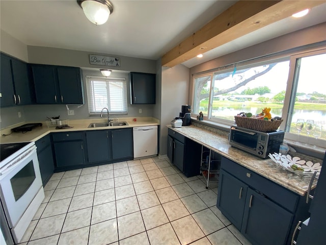 12912 Leadwood Dr, Riverview, FL 33579 - kitchen featuring a sink, white appliances, light tile patterned floors, and light countertops