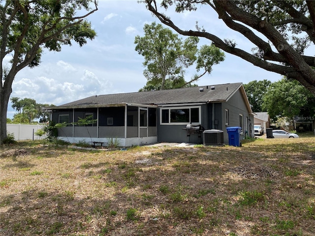 12912 Leadwood Dr, Riverview, FL 33579 - rear view of house with a sunroom, fence, central AC, and a shingled roof