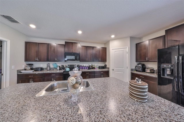 10210 White Linen Ave, Riverview, FL 33578 - kitchen with black appliances, a sink, dark brown cabinets, recessed lighting, and light stone counters