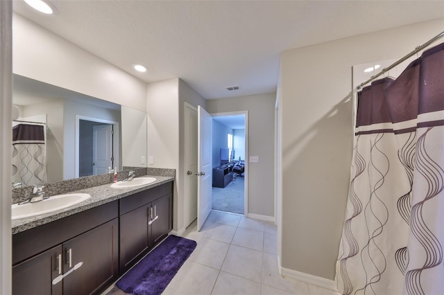 10210 White Linen Ave, Riverview, FL 33578 - bathroom featuring baseboards, double vanity, tile patterned floors, and recessed lighting