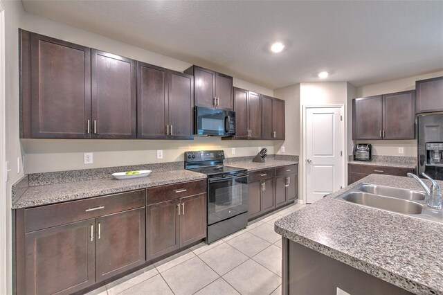 10210 White Linen Ave, Riverview, FL 33578 - kitchen with black appliances, light tile patterned flooring, dark brown cabinets, and recessed lighting