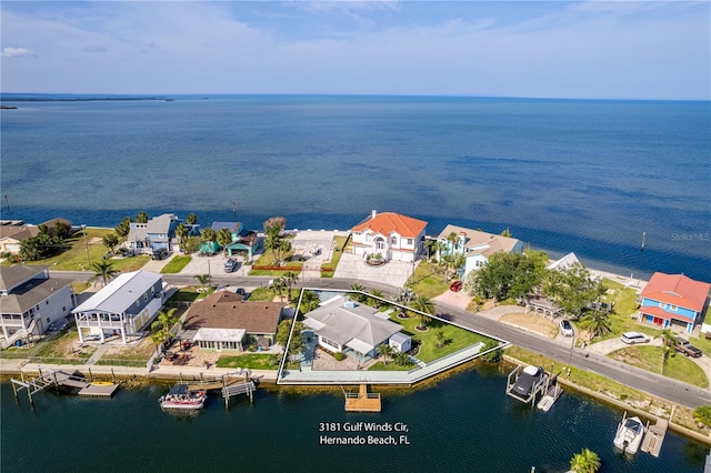 aerial perspective of suburban area with a nearby body of water