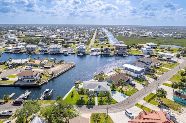 aerial view of residential area featuring a large body of water