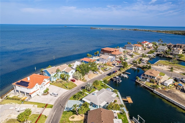 aerial view of residential area featuring a large body of water