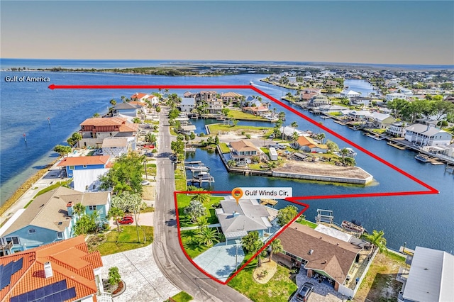 aerial view of residential area featuring a nearby body of water
