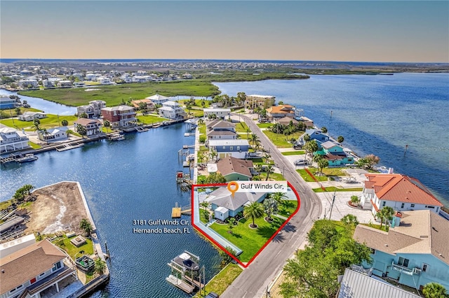 aerial view of residential area with a large body of water and property parcel outlined