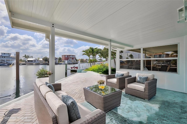 view of patio / terrace with an outdoor living space and a water view