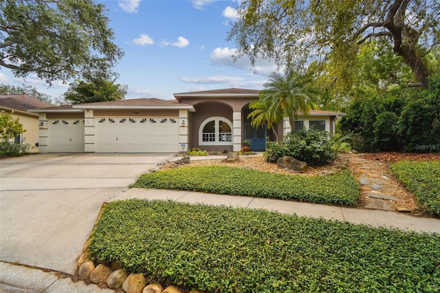 160 Sage Cir, Crystal Beach, FL 34681 - view of front of property featuring an attached garage, concrete driveway, and stucco siding
