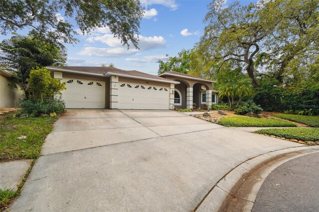 160 Sage Cir, Crystal Beach, FL 34681 - view of front facade with an attached garage, stucco siding, and driveway