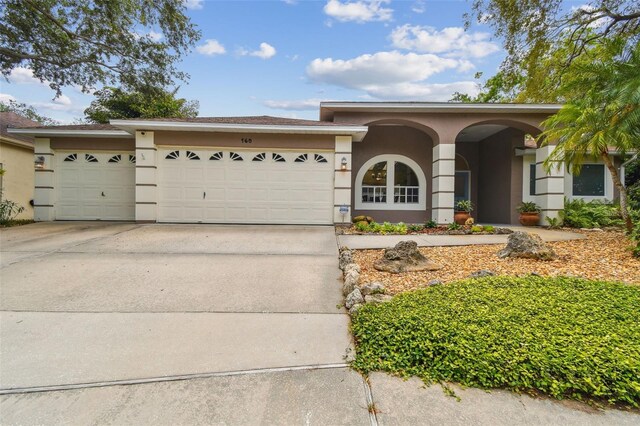 160 Sage Cir, Crystal Beach, FL 34681 - ranch-style home with a garage, driveway, and stucco siding