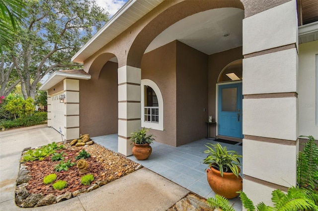 160 Sage Cir, Crystal Beach, FL 34681 - doorway to property with stucco siding