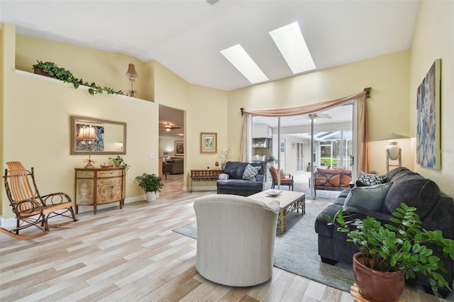 160 Sage Cir, Crystal Beach, FL 34681 - living area with a skylight, light wood finished floors, and lofted ceiling