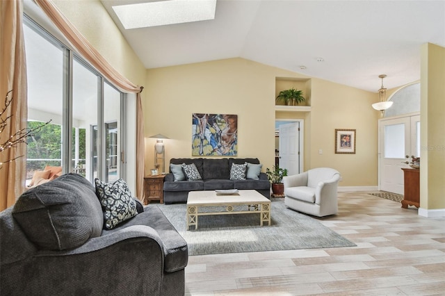160 Sage Cir, Crystal Beach, FL 34681 - living area featuring a skylight, vaulted ceiling, and baseboards