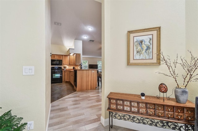 160 Sage Cir, Crystal Beach, FL 34681 - corridor featuring light wood-style floors