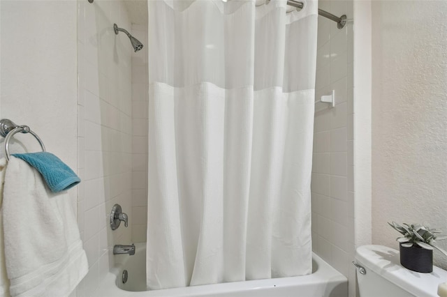 160 Sage Cir, Crystal Beach, FL 34681 - bathroom featuring shower / bath combination with curtain, a textured wall, and toilet