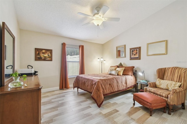 160 Sage Cir, Crystal Beach, FL 34681 - bedroom with vaulted ceiling, a textured ceiling, light wood finished floors, baseboards, and ceiling fan