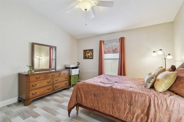 160 Sage Cir, Crystal Beach, FL 34681 - bedroom with a textured ceiling, light wood-style floors, vaulted ceiling, ceiling fan, and baseboards