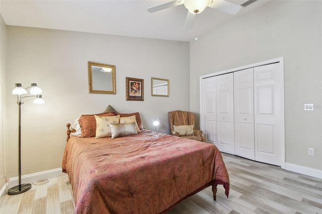 160 Sage Cir, Crystal Beach, FL 34681 - bedroom featuring light wood-style floors, baseboards, lofted ceiling, a closet, and ceiling fan