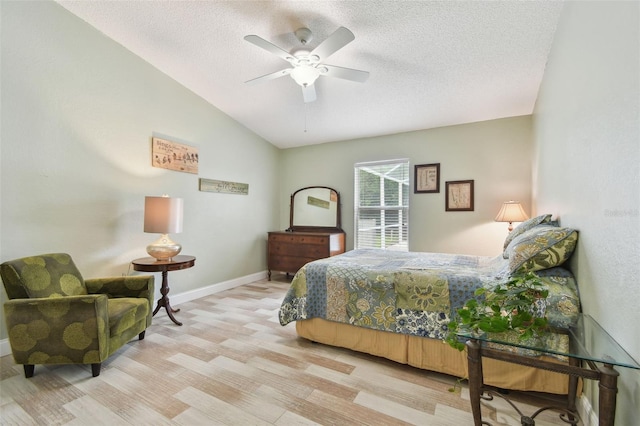 160 Sage Cir, Crystal Beach, FL 34681 - bedroom with a textured ceiling, wood finished floors, lofted ceiling, baseboards, and a ceiling fan