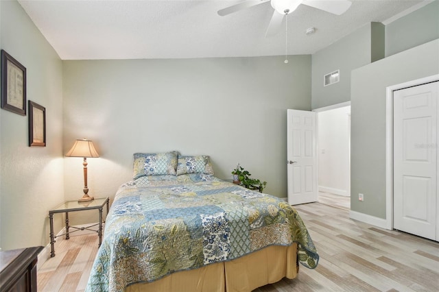 160 Sage Cir, Crystal Beach, FL 34681 - bedroom featuring light wood finished floors, high vaulted ceiling, a ceiling fan, and baseboards