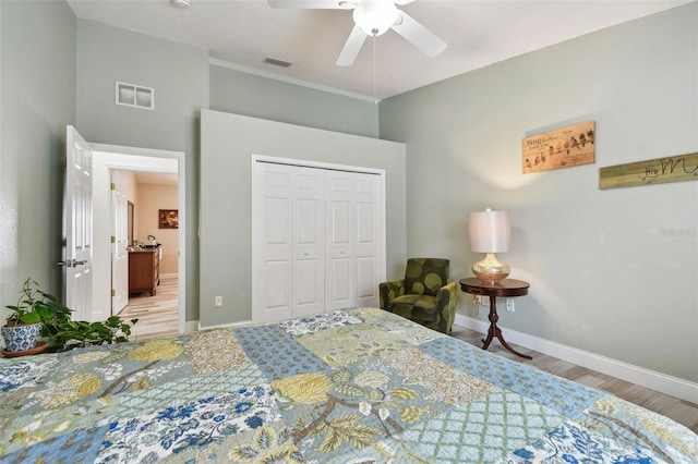 160 Sage Cir, Crystal Beach, FL 34681 - bedroom featuring wood finished floors, a closet, baseboards, and ceiling fan