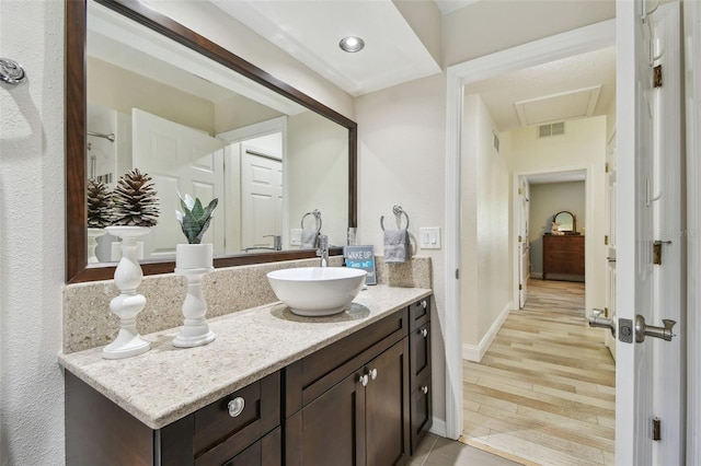 160 Sage Cir, Crystal Beach, FL 34681 - bathroom with vanity, wood finished floors, and baseboards