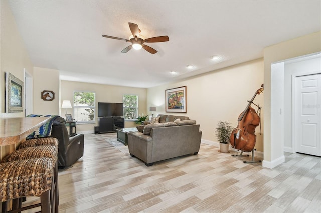 160 Sage Cir, Crystal Beach, FL 34681 - living room featuring ceiling fan, light wood-type flooring, and baseboards