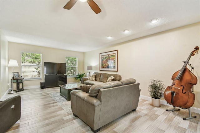 160 Sage Cir, Crystal Beach, FL 34681 - living room featuring light wood-style flooring, baseboards, and a ceiling fan