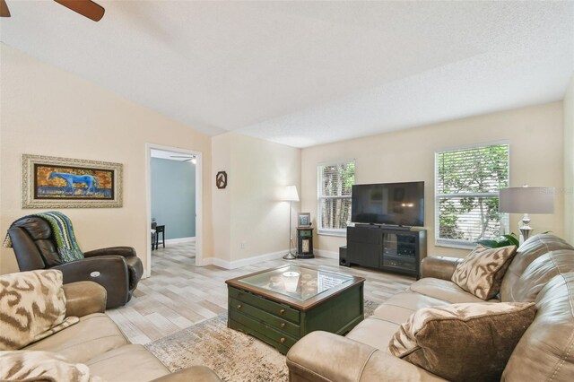 160 Sage Cir, Crystal Beach, FL 34681 - living area featuring light wood finished floors, a ceiling fan, and baseboards