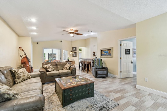 160 Sage Cir, Crystal Beach, FL 34681 - living area with light wood-style floors, vaulted ceiling, baseboards, and ceiling fan
