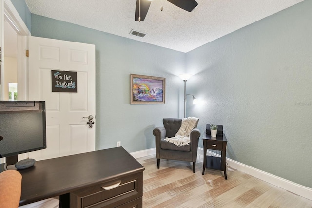 160 Sage Cir, Crystal Beach, FL 34681 - living area with light wood-style flooring, baseboards, ceiling fan, a textured ceiling, and an office area