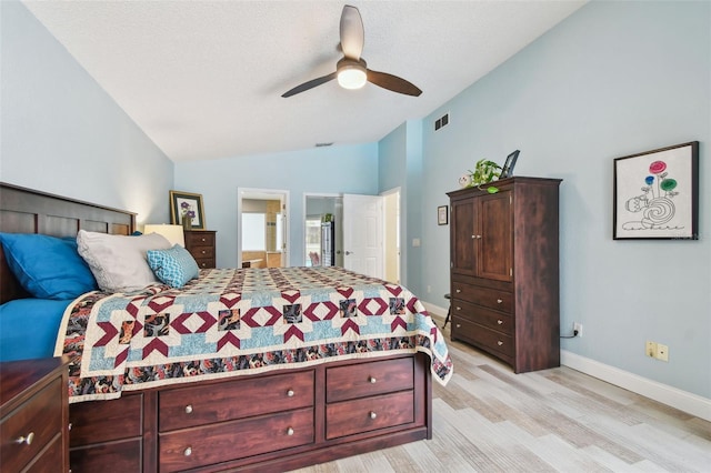 160 Sage Cir, Crystal Beach, FL 34681 - bedroom with lofted ceiling, light wood-style floors, baseboards, a ceiling fan, and a textured ceiling
