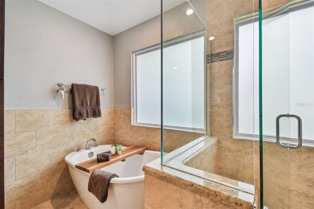160 Sage Cir, Crystal Beach, FL 34681 - full bathroom featuring tiled shower, tile walls, and a soaking tub