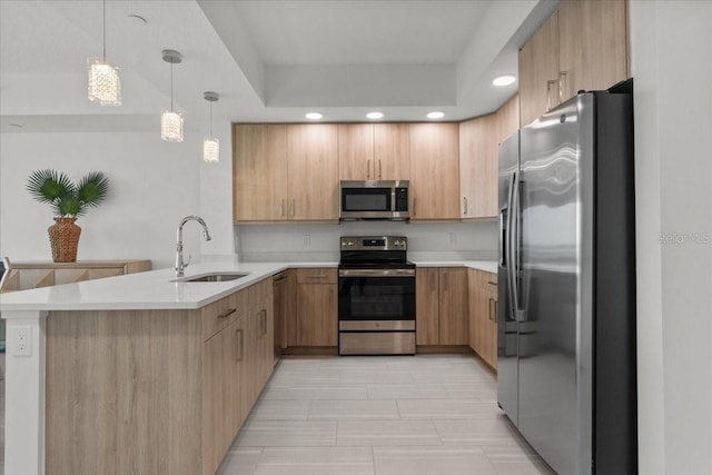 415 Island Way Unit 303, Clearwater Beach, FL 33767 - kitchen with stainless steel appliances, a sink, a peninsula, light countertops, and recessed lighting