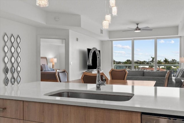 415 Island Way Unit 303, Clearwater Beach, FL 33767 - kitchen featuring a sink, open floor plan, light countertops, ceiling fan, and pendant lighting