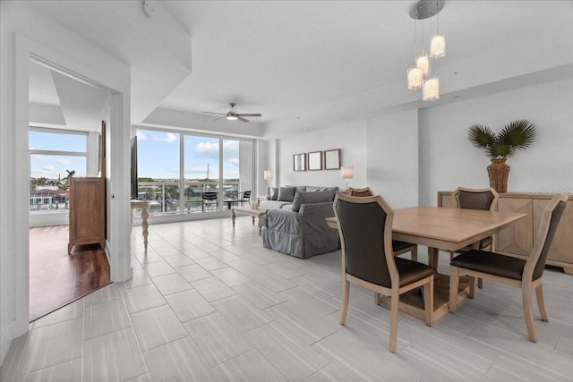 415 Island Way Unit 303, Clearwater Beach, FL 33767 - dining room featuring ceiling fan, healthy amount of natural light, and a chandelier