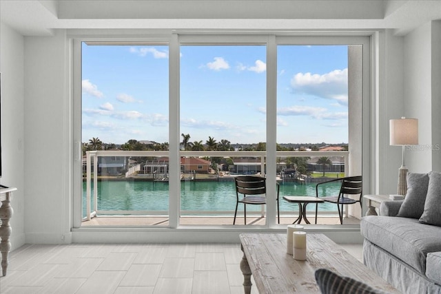 415 Island Way Unit 303, Clearwater Beach, FL 33767 - doorway to outside featuring a water view and healthy amount of natural light