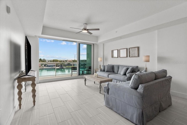 415 Island Way Unit 303, Clearwater Beach, FL 33767 - living room with a ceiling fan and a textured ceiling