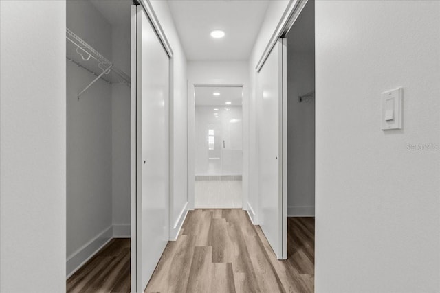 415 Island Way Unit 303, Clearwater Beach, FL 33767 - hall featuring wood finished floors, baseboards, and recessed lighting