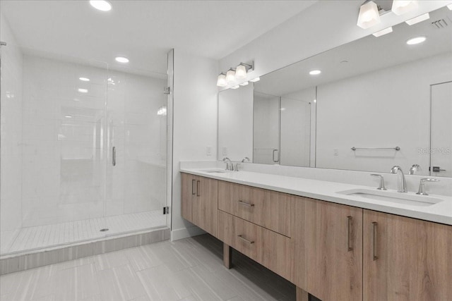 415 Island Way Unit 303, Clearwater Beach, FL 33767 - bathroom featuring a stall shower, tile patterned floors, double vanity, and recessed lighting