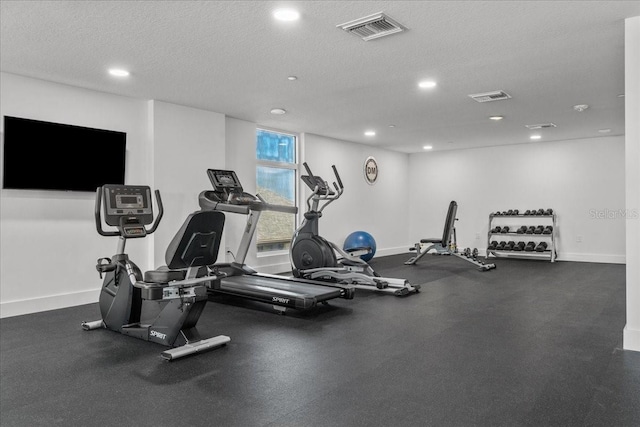 415 Island Way Unit 303, Clearwater Beach, FL 33767 - gym featuring baseboards, recessed lighting, and a textured ceiling
