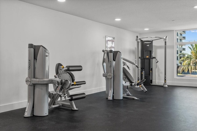 415 Island Way Unit 303, Clearwater Beach, FL 33767 - workout area with baseboards, recessed lighting, and a textured ceiling