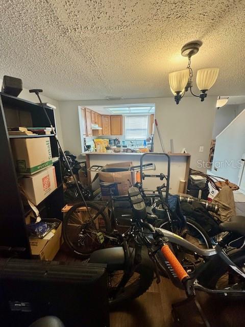 144 Douglas Rd W Unit F, Oldsmar, FL 34677 - dining room featuring a textured ceiling and wood finished floors