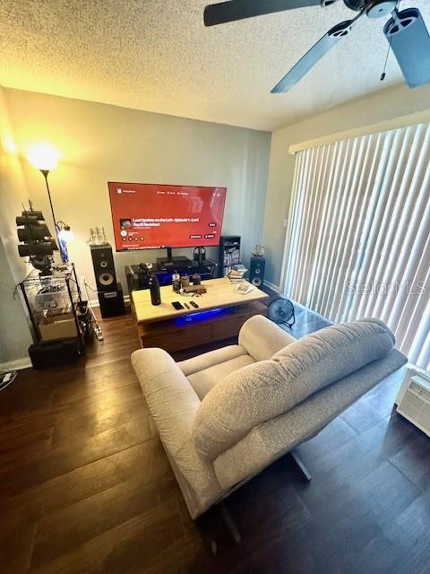 144 Douglas Rd W Unit F, Oldsmar, FL 34677 - living room with ceiling fan, a textured ceiling, wood finished floors, and baseboards