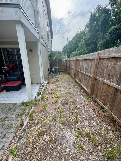 144 Douglas Rd W Unit F, Oldsmar, FL 34677 - fenced backyard with central AC and a patio area