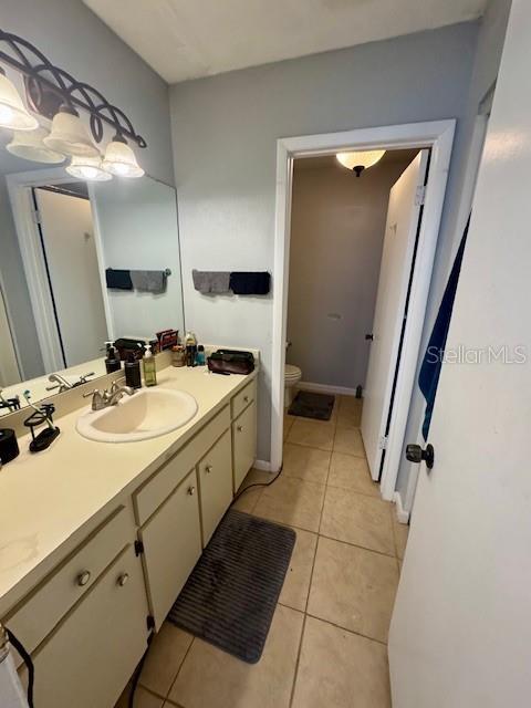 144 Douglas Rd W Unit F, Oldsmar, FL 34677 - bathroom with toilet, vanity, and tile patterned flooring